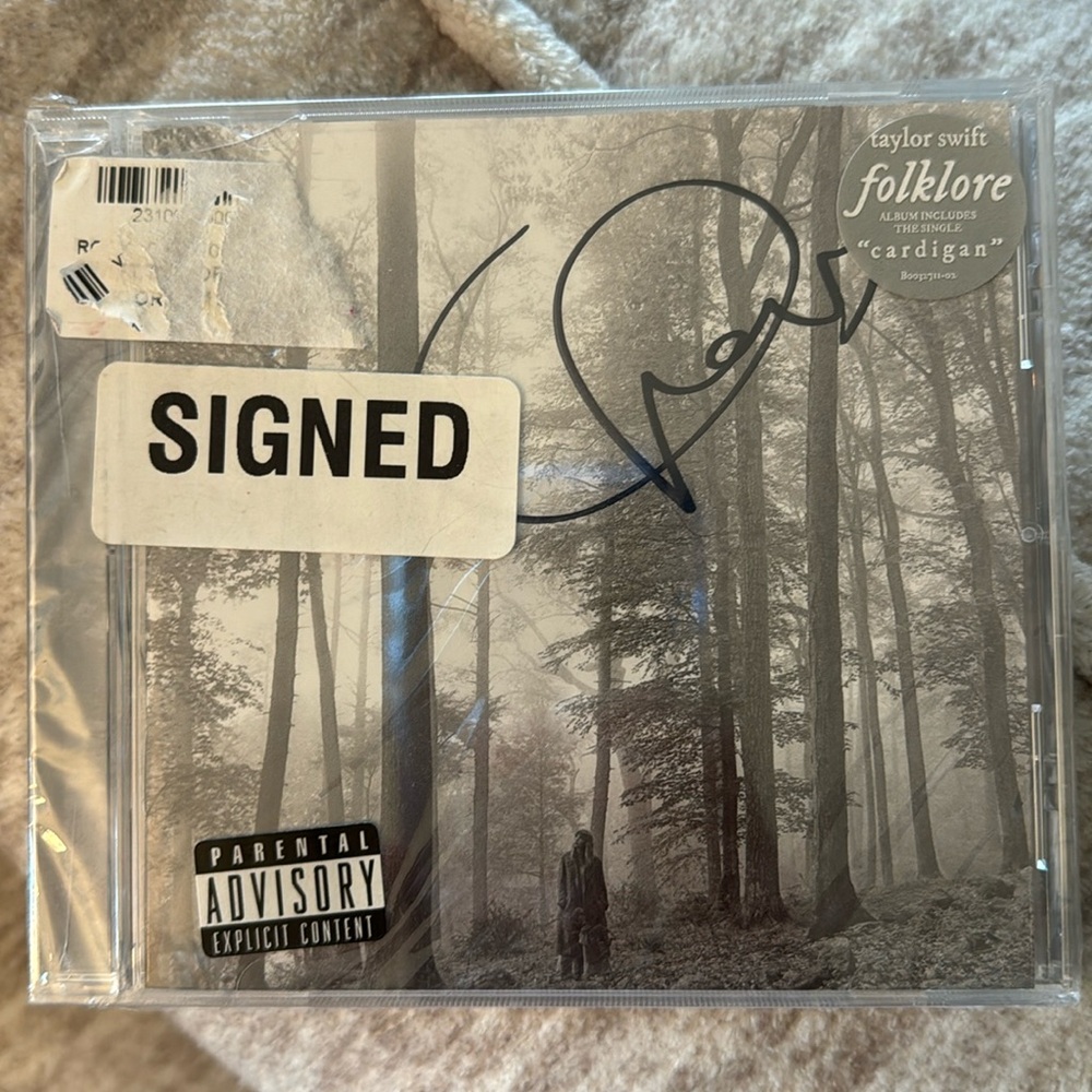 Sealed in plastic and signed Taylor Swift cd.